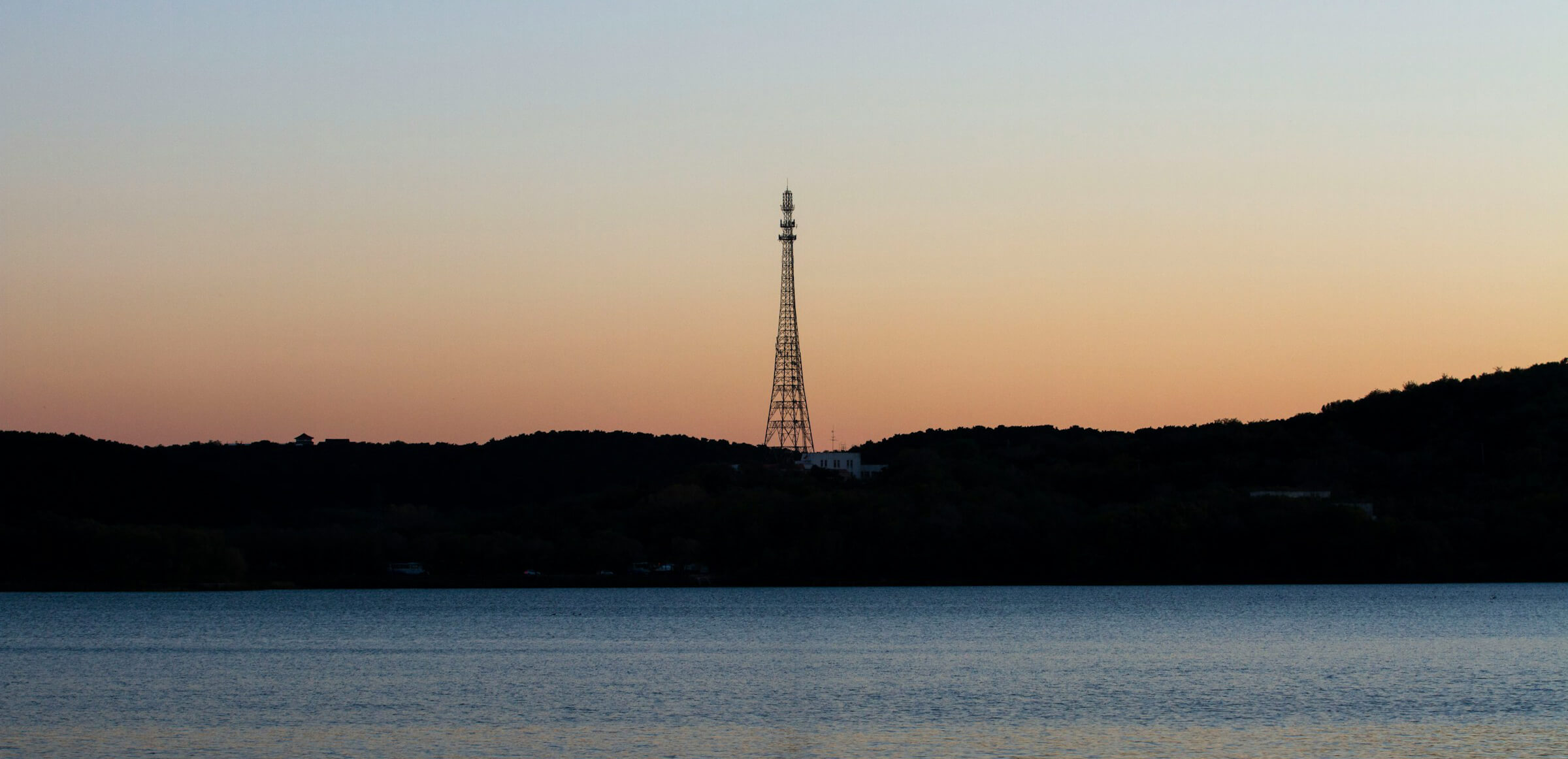 Photo of a telecommunications mast in the horizon.